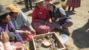 After 30 minutes, we dig up the potatoes and eat. Maria, Maria, and Alex.