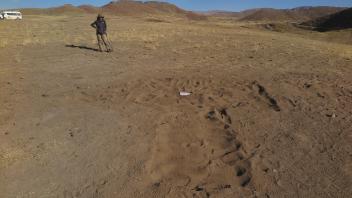 At the end of it all, we fill the excavation units. Izzy in the background. 
