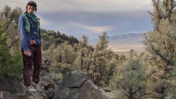 Bri stands on an outlook over TNKG while hiking down the mesa.
