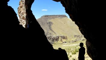 Dario peers out a cave site in the study area.