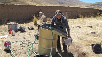 Dario processing archaeological sediments by flotation in the village of Totorani.