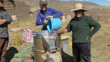 Dr. BrieAnna Langlie and Virginia processing archaeological sediments by flotation in the village of Totorani.