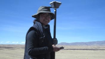 Jessica using the GNSS unit to map features.