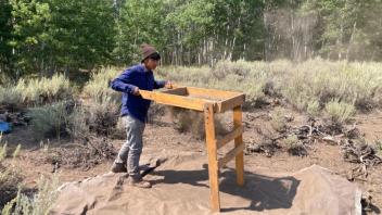 Lu diligently screens soil for artifacts.
