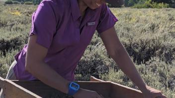 MacKennah screens dirt using her Marshalltown trowel.