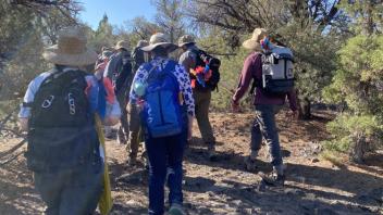 The crew hikes up the TNKG Mesa for the first time.