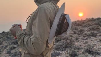 Tom launches the drone at sunrise.