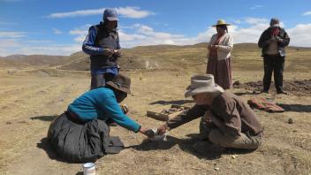 Totavina and Billy dip the huatia in chacu--a type of delicious clay salsa.