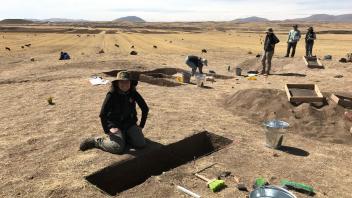 Test units are placed around the site in areas of high artifact concentration. Izzy excavating.