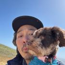 photo of man carrying dog