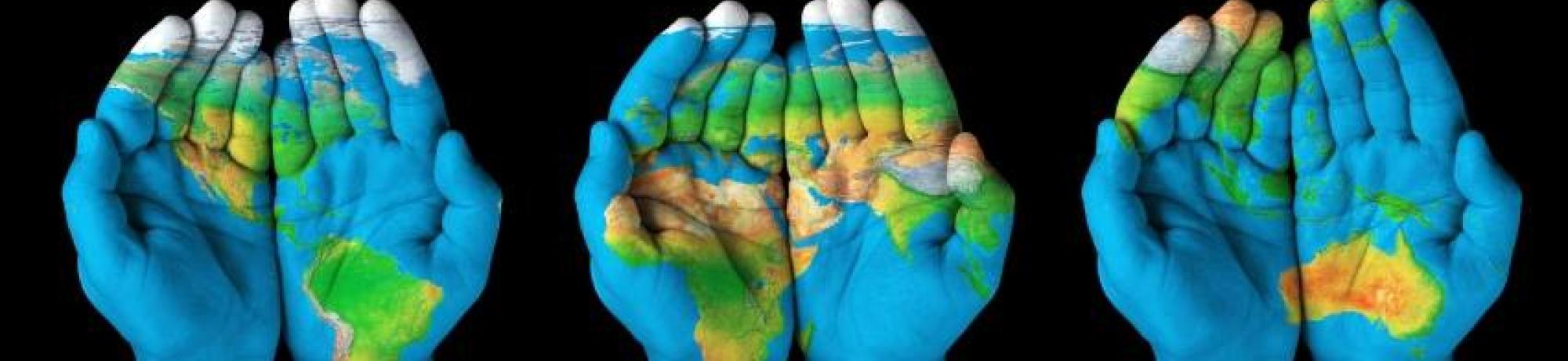 world map painted on 3 pair of hands